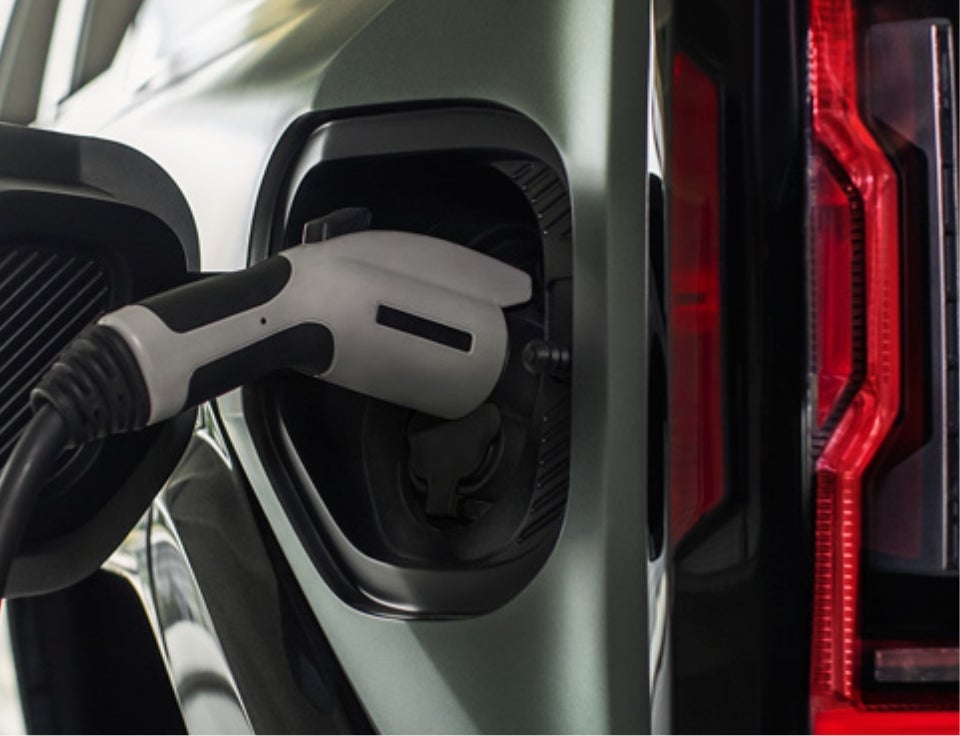 Close up of charging port with charger plugged in on a GMC Hummer EV SUV - Glynn Smith GMC in OPELIKA AL