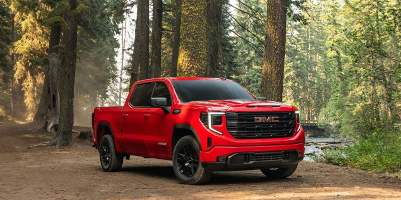 Dynamic driving shot of the 2026 GMC Sierra 1500 Denali Ultimate