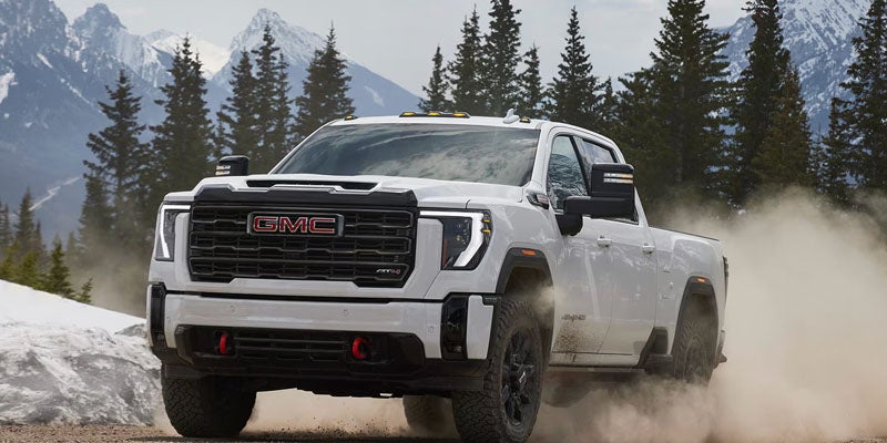 2026 GMC Sierra 2500 HD truck conquering rugged terrain near Opelika, AL
